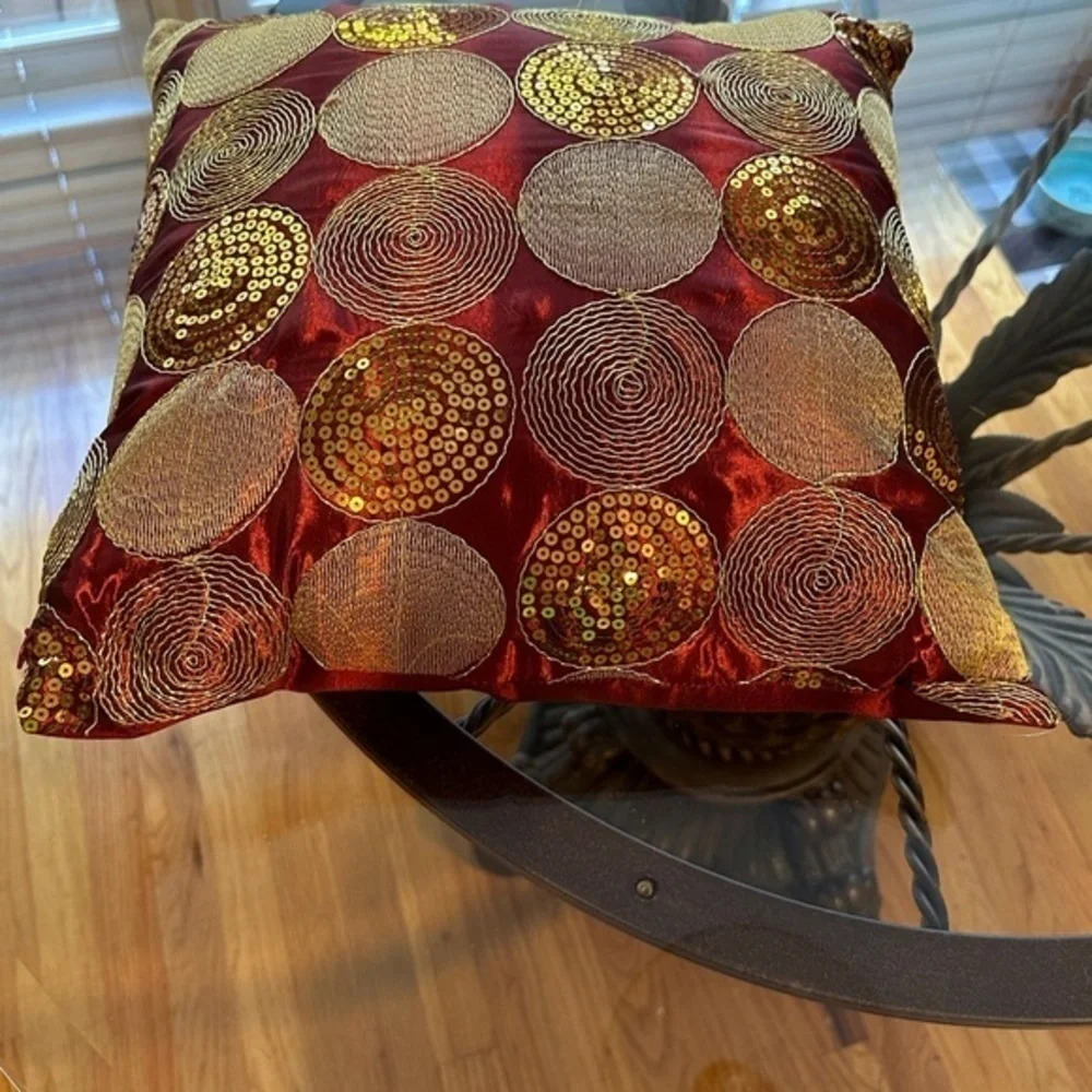 Dark red pillow with gold accents